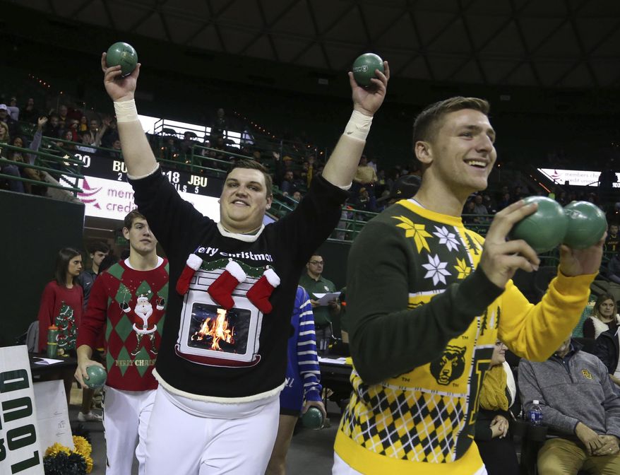 Baylor cheerleaders wearing Christmas sweaters head to the court during the first half of an NCAA college basketball game against John Brown, Sunday, Dec. 18, 2016, in Waco, Texas. (Rod Aydelotte/Waco Tribune-Herald via AP)