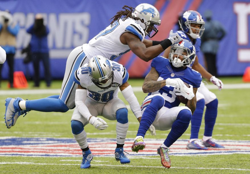 Detroit Lions outside linebacker Josh Bynes (57) and Asa Jackson (30) attempt to tackle New York Giants&#39; Odell Beckham (13) during the first half of an NFL football game Sunday, Dec. 18, 2016, in East Rutherford, N.J. (AP Photo/Seth Wenig)