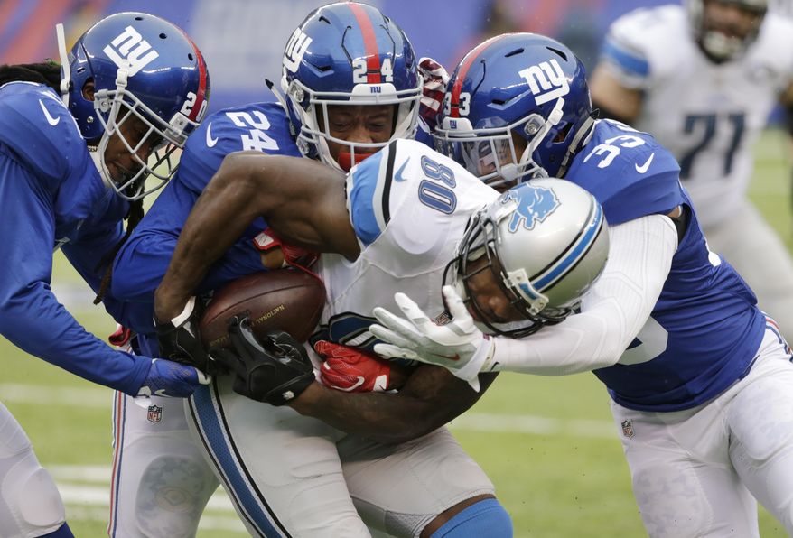Detroit Lions wide receiver Anquan Boldin (80) is tackled by New York Giants&#39; Janoris Jenkins (20), Eli Apple (24) and Andrew Adams (33) during the first half of an NFL football game Sunday, Dec. 18, 2016, in East Rutherford, N.J. (AP Photo/Seth Wenig)