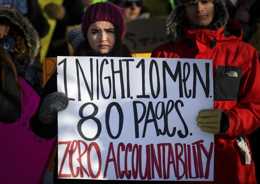 Lauren Wetzsteon, a journalism student at the University of Minnesota, participates in a rally to support the victim of an alleged sexual assault that led to the suspension of 10 football players, outside TCF Bank Stadium at the University of Minnesota in Minneapolis, Minn., on Saturday, Dec. 17, 2016. The team had threatened a boycott of the upcoming Holiday Bowl to protest the suspension of their teammates who were allegedly involved in the September encounter with the woman. (Aaron Lavinsky/Star Tribune via AP)