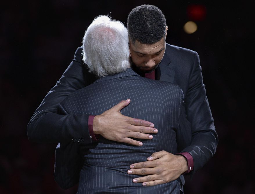 San Antonio Spurs legend Tim Duncan, right, hugs Spurs head coach Gregg Popovich during Duncan's jersey retirement ceremony, Sunday, Dec. 18, 2016, in San Antonio. (AP Photo/Darren Abate)2
