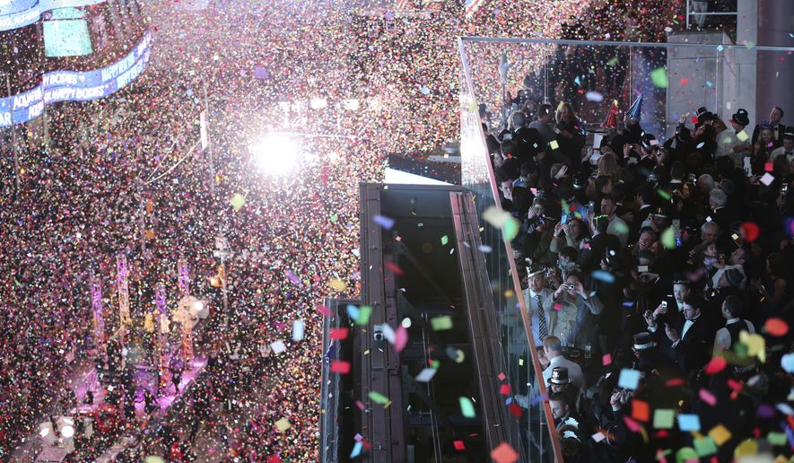 FILE - In this Jan. 1, 2016, file photo, revelers celebrate as confetti flies over New York&#39;s Times Square after the clock strikes midnight during the New Year&#39;s Eve celebration as seen from the Marriott Marquis hotel. New Year&#39;s Eve is the party of the year, for those who like to party, but what happens when your dreams are too big for your budget. For one, money experts say, be willing to compromise while still having fun (AP Photo/Mary Altaffer, File)