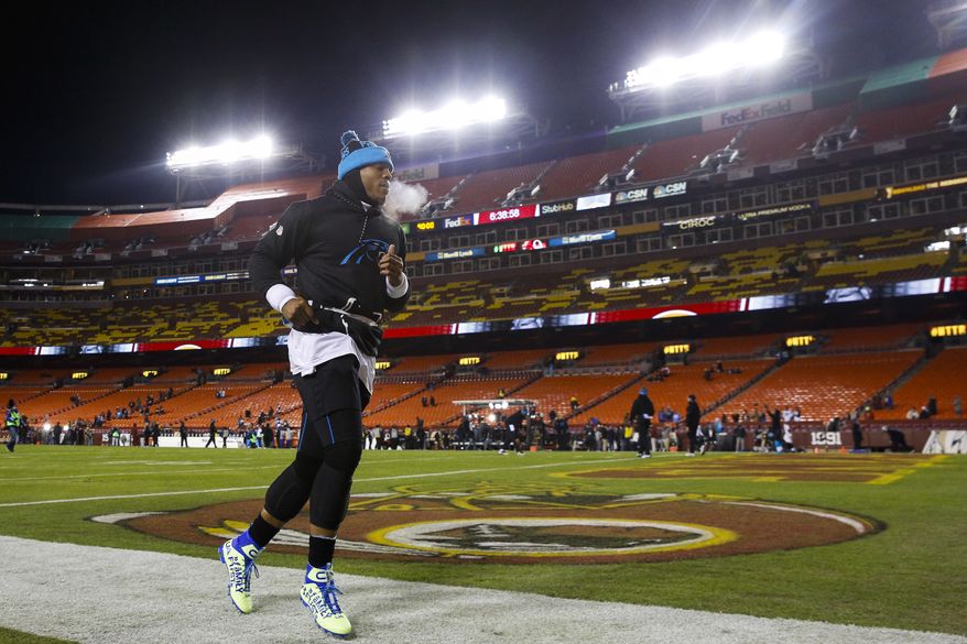 Carolina Panthers quarterback Cam Newton (1) warms up by running along the sidelines before an NFL football game against the Washington Redskins on a chilly night in Landover, Md., Monday, Dec. 19, 2016. (AP Photo/Patrick Semansky)