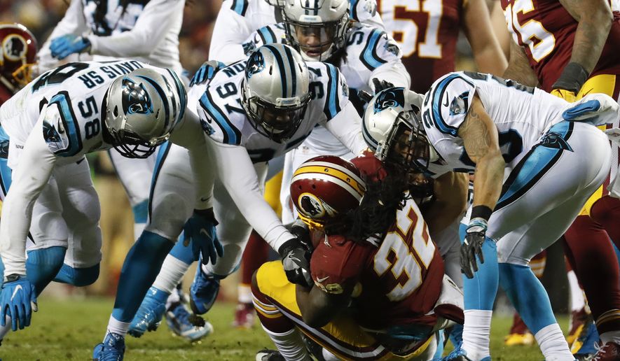 Washington Redskins running back Rob Kelley (32) is overwhelmed by the Carolina Panthers defense during the second half of an NFL football game in Landover, Md., Monday, Dec. 19, 2016. (AP Photo/Alex Brandon)