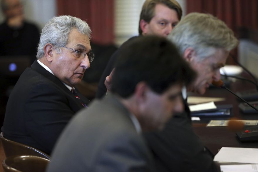 FILE- In this Dec. 15, 2016, file photo, Richard Vezza, left, publisher of the Star-Ledger newspaper, and others listen as Stephen W. Parker, right, co-owner and co-publisher of New Jersey Hills Media Group, addresses members of the New Jersey Assembly Appropriations Committee, in Trenton, N.J. Legislation in New Jersey supported by Republican Gov. Chris Christie to scrap a requirement that local governments publish legal notices in newspapers and instead allow them to post the notices on their own websites is set for a vote. (AP Photo/Mel Evans, File)