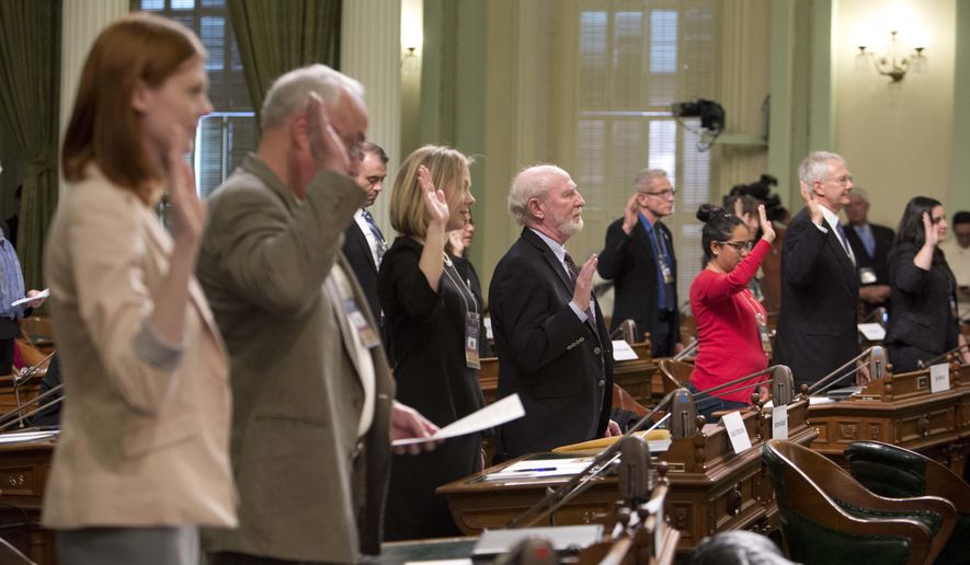 Members of the California Electoral College took an oath before casting their votes for president and vice president in December. "Right now, there is no reason for a Republican in California to vote in the presidential election," said Equal Citizens spokesman Ken Scudder, adding that the Equal Votes project proposes a proportional allocation system that could improve voter turnout in solidly red or blue states. (Associated Press/File)