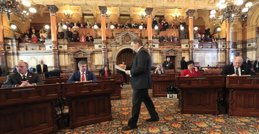 Ballots are passed out to the six Kansas electoral college electors in the Senate chamber of the Kansas Statehouse in Topeka, Kan., Monday, Dec. 19, 2016. (AP Photo/Orlin Wagner)