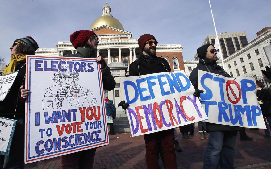 Protesters gather outside the Statehouse prior to the electoral college vote in Boston, Monday, Dec. 19, 2016. (AP Photo/Charles Krupa)