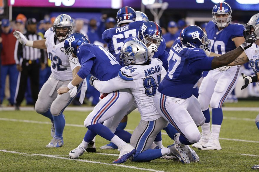 New York Giants quarterback Eli Manning (10) is sacked by Detroit Lions&#39; Ezekiel Ansah (94) during the second half of an NFL football game Sunday, Dec. 18, 2016, in East Rutherford, N.J. (AP Photo/Seth Wenig)