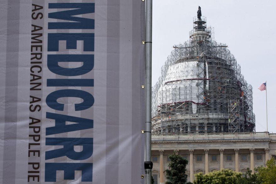FILE - In this July 30, 2015 file photo, a sign supporting Medicare is seen on Capitol Hill in Washington. A government report says Medicare beneficiaries can end up with higher hospital bills for some medical services as outpatients than as inpatients. In the topsy-turvy world of Medicare billing, you may pay more for outpatient care. (AP Photo/Jacquelyn Martin, File)
