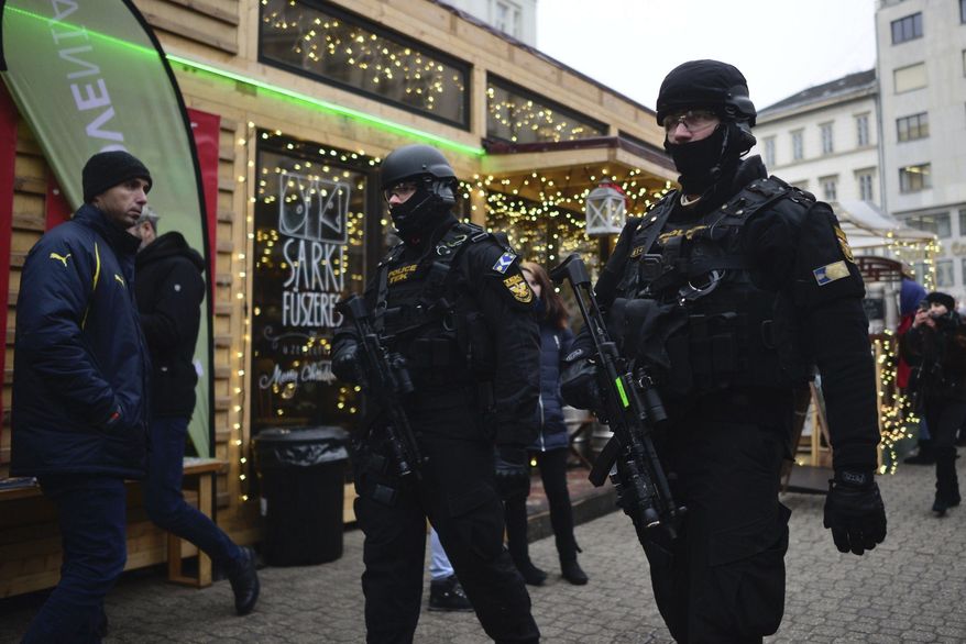 Police officers of the Counter Terrorism Centre with sub-machine guns patrol at a Christmas market in downtown Budapest, Hungary, Tuesday, Dec. 20, 2016 as security has been beefed up at venues visited by large number of people after a truck ran into a crowded Christmas market in Berlin last night killing several people. (Janos Marjai/MTI via AP)