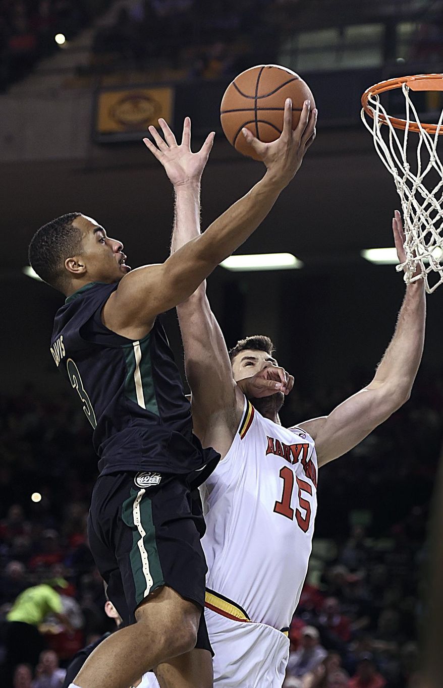 Maryland's Michal Cekovsky, right, defends as Charlotte's Jon Davis scores during the second half of an NCAA college basketball game Tuesday, Dec. 20, 2016, in Baltimore. Maryland won 88-72. (AP Photo/Gail Burton)