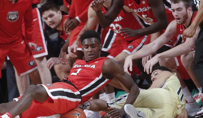 Georgia guard Jordan Harris (2) and Georgia Tech guard Josh Heath (11) dive for a loose ball in front of the Georgia bench the first half of an NCAA college basketball game Tuesday, Dec. 20, 2016, in Atlanta. (AP Photo/John Bazemore)