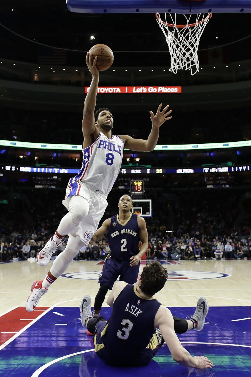 Philadelphia 76ers' Jahlil Okafor (8) goes up for a shot over New Orleans Pelicans' Omer Asik (3) during the first half of an NBA basketball game, Tuesday, Dec. 20, 2016, in Philadelphia. (AP Photo/Matt Slocum)