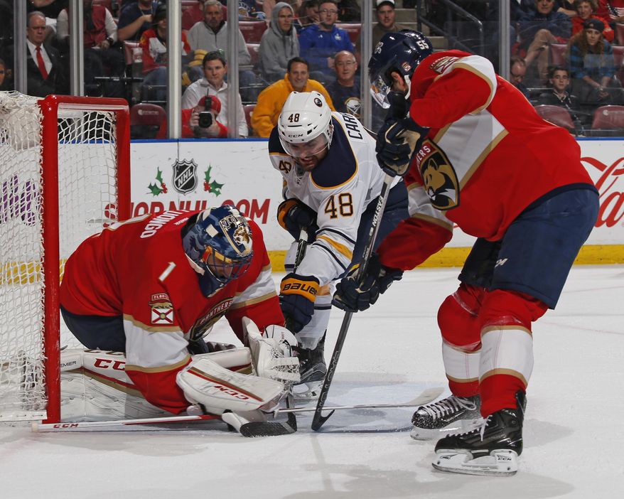 Florida Panthers defenseman Jason Demers (55) helps defend the net as Florida Panthers goaltender Roberto Luongo (1) stops a shot by Buffalo Sabres left wing William Carrier (48) during the second period of an NHL hockey game, Tuesday, Dec. 20, 2016, in Sunrise, Fla. (AP Photo/Joel Auerbach)