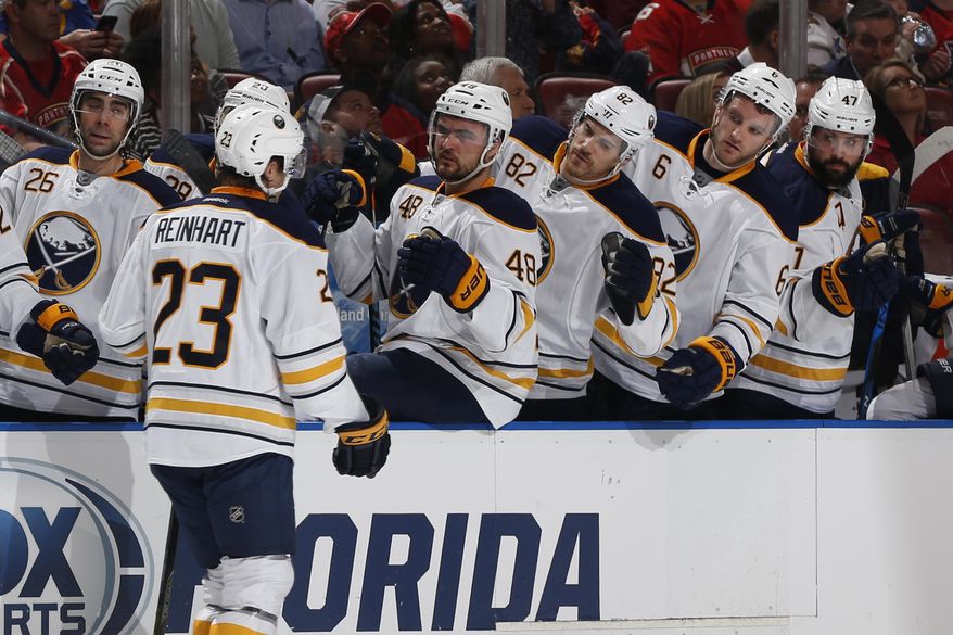 Teammates congratulate Buffalo Sabres center Sam Reinhart (23) after he scored a goal against the Florida Panthers during the second period of an NHL hockey game, Tuesday, Dec. 20, 2016, in Sunrise, Fla. (AP Photo/Joel Auerbach)