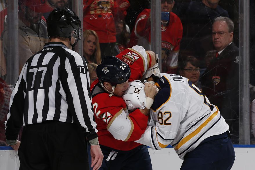 Linesman Tim Nowak (77) looks on as Florida Panthers right wing Shawn Thornton (22) and Buffalo Sabres left wing Marcus Foligno (82) fight during the second period of an NHL hockey game, Tuesday, Dec. 20, 2016, in Sunrise, Fla. (AP Photo/Joel Auerbach)