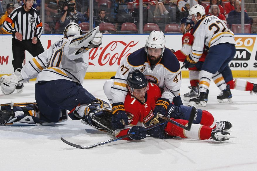 Buffalo Sabres defenseman Zach Bogosian (47) checks Florida Panthers center Colton Sceviour (7) in front of Buffalo Sabres goaltender Robin Lehner (40) during the first period of an NHL hockey game, Tuesday, Dec. 20, 2016, in Sunrise, Fla. (AP Photo/Joel Auerbach)