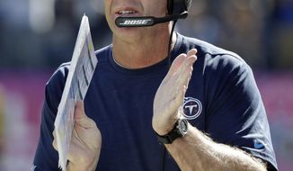 FILE - In this Oct. 23, 2016, file photo, Tennessee Titans head coach Mike Mularkey applauds a play in the first half of an NFL football game against the Indianapolis Colts in Nashville, Tenn. His confidence has filtered through the Titans who are poised to go from the worst in the NFL a year ago to first in the AFC South with two games left. They visit Jacksonville on Saturday. (AP Photo/James Kenney, File)