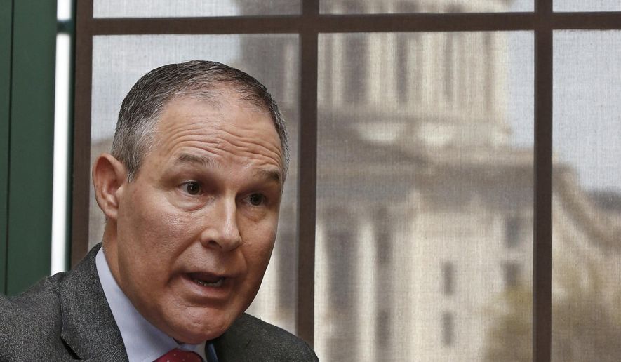  Scott Pruitt, Oklahoma Attorney General, gestures as he speaks during an interview in Oklahoma City. The Oklahoma Capitol is at rear. Pruitt is President-elect Donald Trump&#39;s nominee to head the Environmental Protection Agency. (AP Photo/Sue Ogrocki, File)