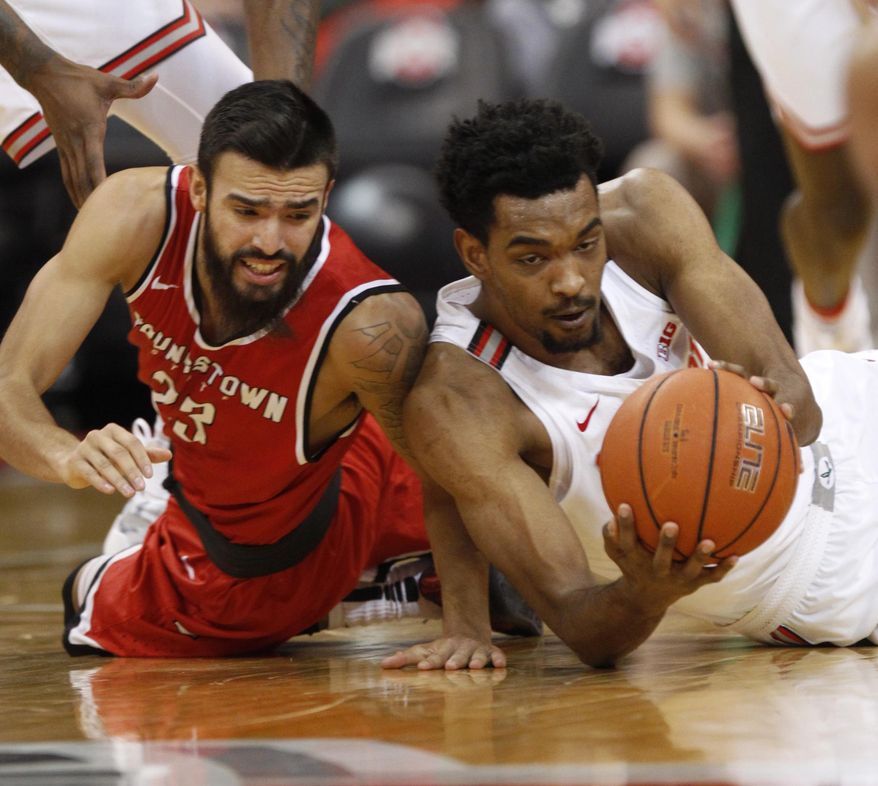 Ohio State forward Keita Bates-Diop, right, works for a loose ball against Youngstown State guard Francisco Santiago during the first half of an NCAA college basketball game in Columbus, Ohio, Tuesday, Dec. 20, 2016. (AP Photo/Paul Vernon)