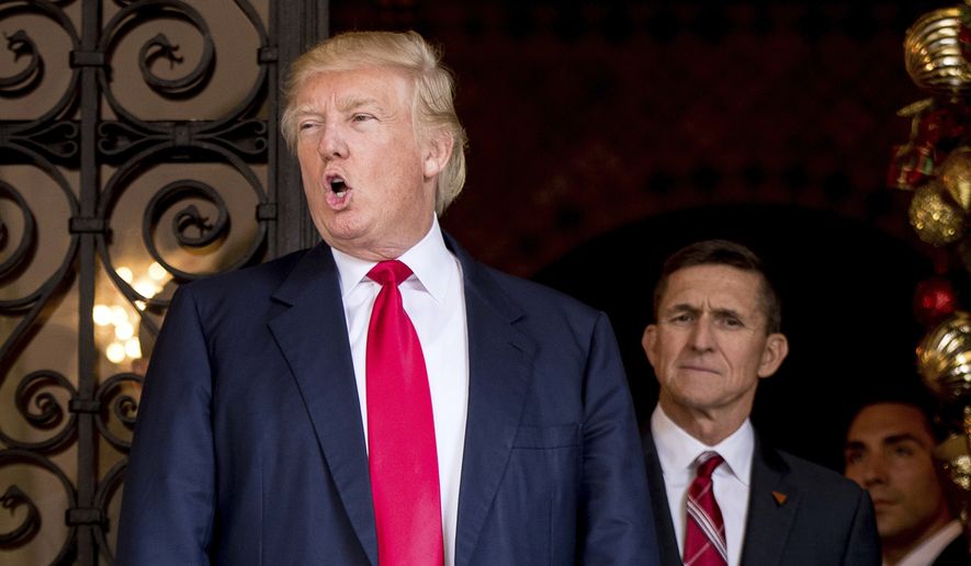 President-elect Donald Trump, left, accompanied by retired Gen. Michael Flynn, a senior adviser to President-elect Donald Trump, center, speaks to members of the media at Mar-a-Lago, in Palm Beach, Fla., Wednesday, Dec. 21, 2016. (AP Photo/Andrew Harnik) **FILE**