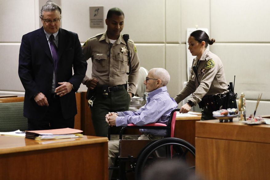 Real estate heir Robert Durst, center, is brought into a courtroom in the wheelchair for a hearing Wednesday, Dec. 21, 2016, in Los Angeles. At left is his attorney David Chesnoff. (AP Photo/Jae C. Hong, Pool)