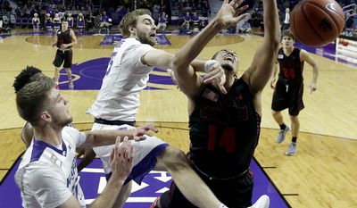 Kansas State&#x27;s Austin Budke, center, and Gardner-Webb&#x27;s Brandon Miller, right, vie for a rebound during the first half of an NCAA college basketball game Wednesday, Dec. 21, 2016, in Manhattan, Kan. (AP Photo/Charlie Riedel)
