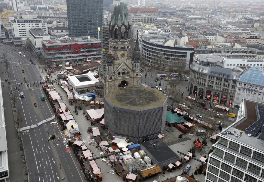 Debris is seen between the huts in Berlin, Germany, Wednesday, Dec. 21, 2016, two days after a truck ran into a crowded Christmas market and killed several people. (AP Photo/Michael Sohn)