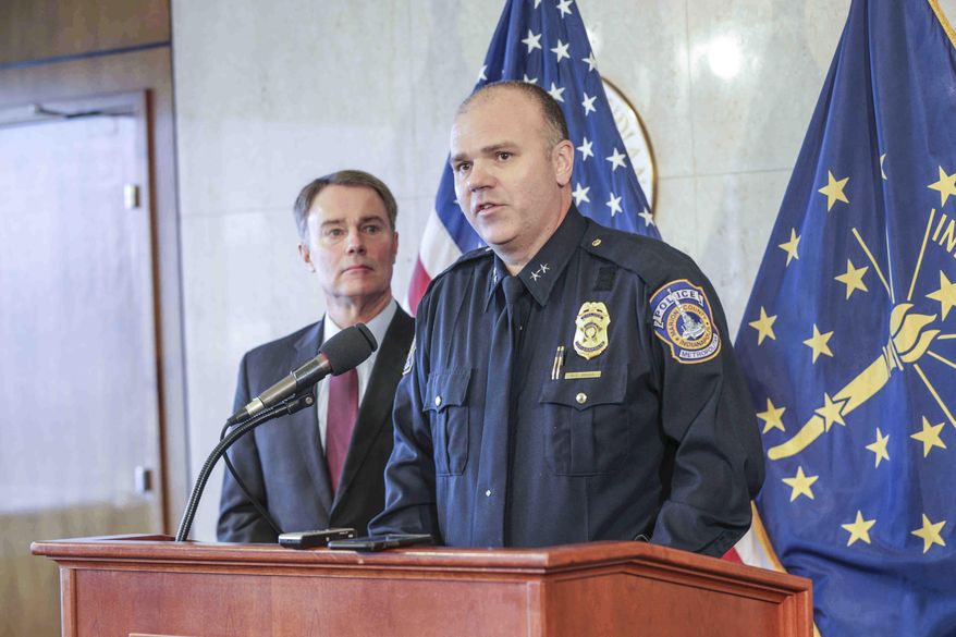 Indianapolis Mayor Joe Hogsett, left, listens as Indianapolis Police Chief Troy Riggs, right, announces his resignation during a press conference at the City County Building, Wednesday, Dec. 21, 2016, in Indianapolis. (Michelle Pemberton/The Indianapolis Star via AP)