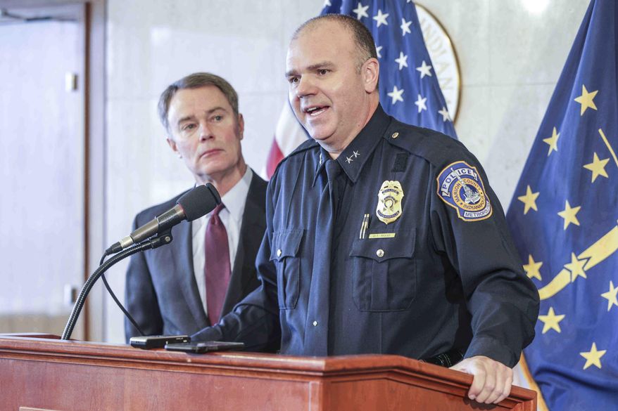 Indianapolis Mayor Joe Hogsett, left, listens as Indianapolis Police Chief Troy Riggs, right, announces his resignation during a press conference at the City County Building, Wednesday, Dec. 21, 2016, in Indianapolis. (Michelle Pemberton/The Indianapolis Star via AP)