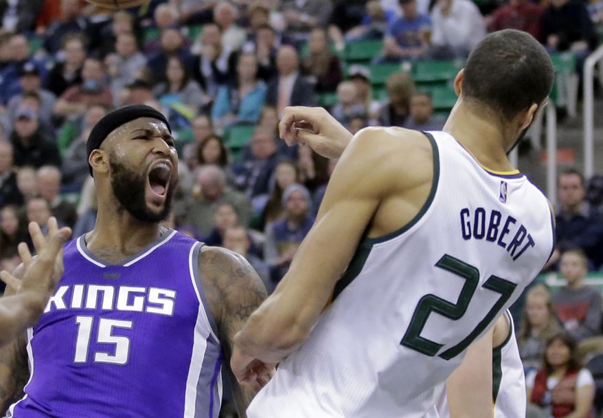 Sacramento Kings forward DeMarcus Cousins (15) reacts after dunking on Utah Jazz center Rudy Gobert (27) in the first half during an NBA basketball game Wednesday, Dec. 21, 2016, in Salt Lake City. (AP Photo/Rick Bowmer)