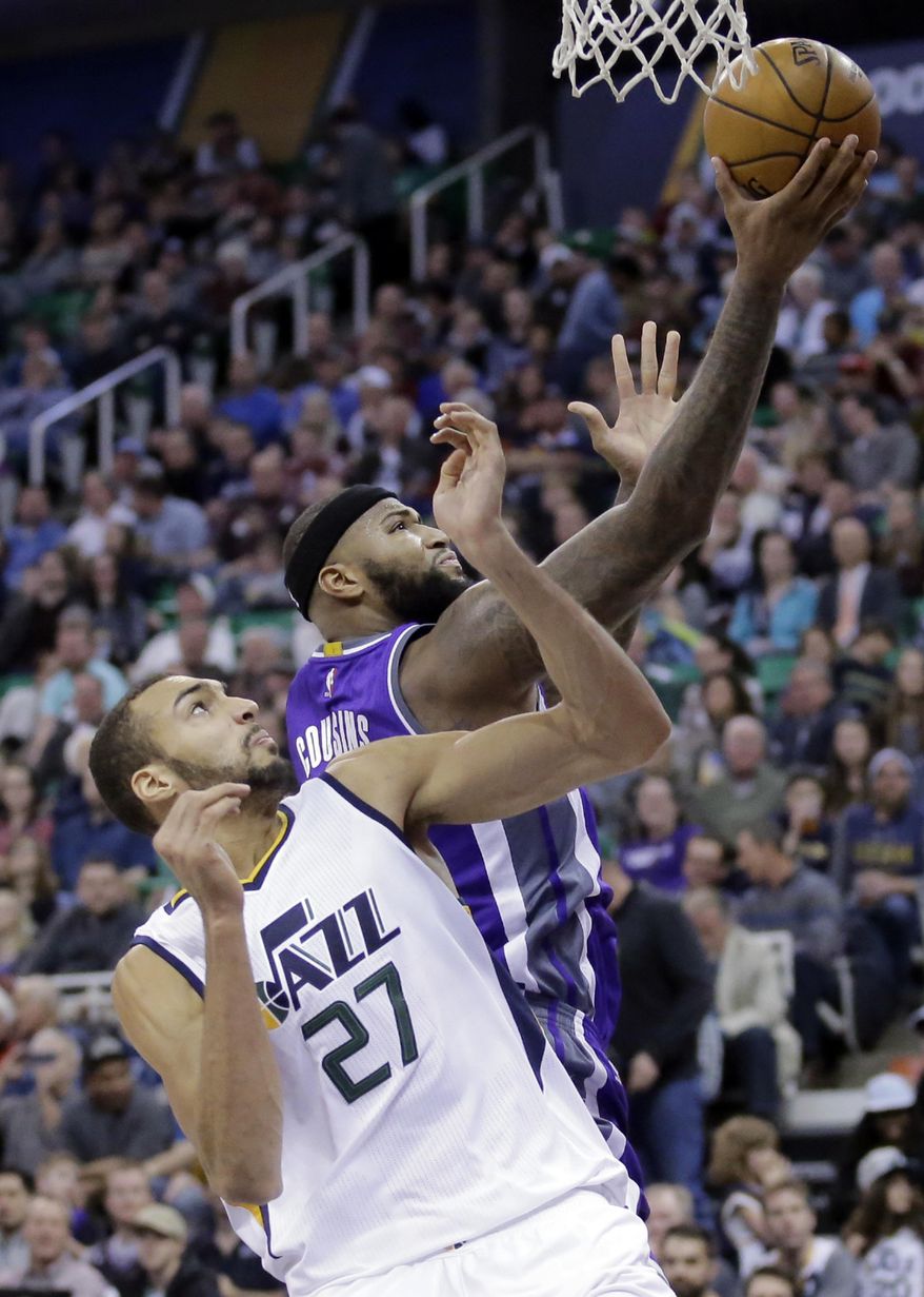 Utah Jazz center Rudy Gobert (27) defends against Sacramento Kings forward DeMarcus Cousins, rear, in the first half during an NBA basketball game Wednesday, Dec. 21, 2016, in Salt Lake City. (AP Photo/Rick Bowmer)