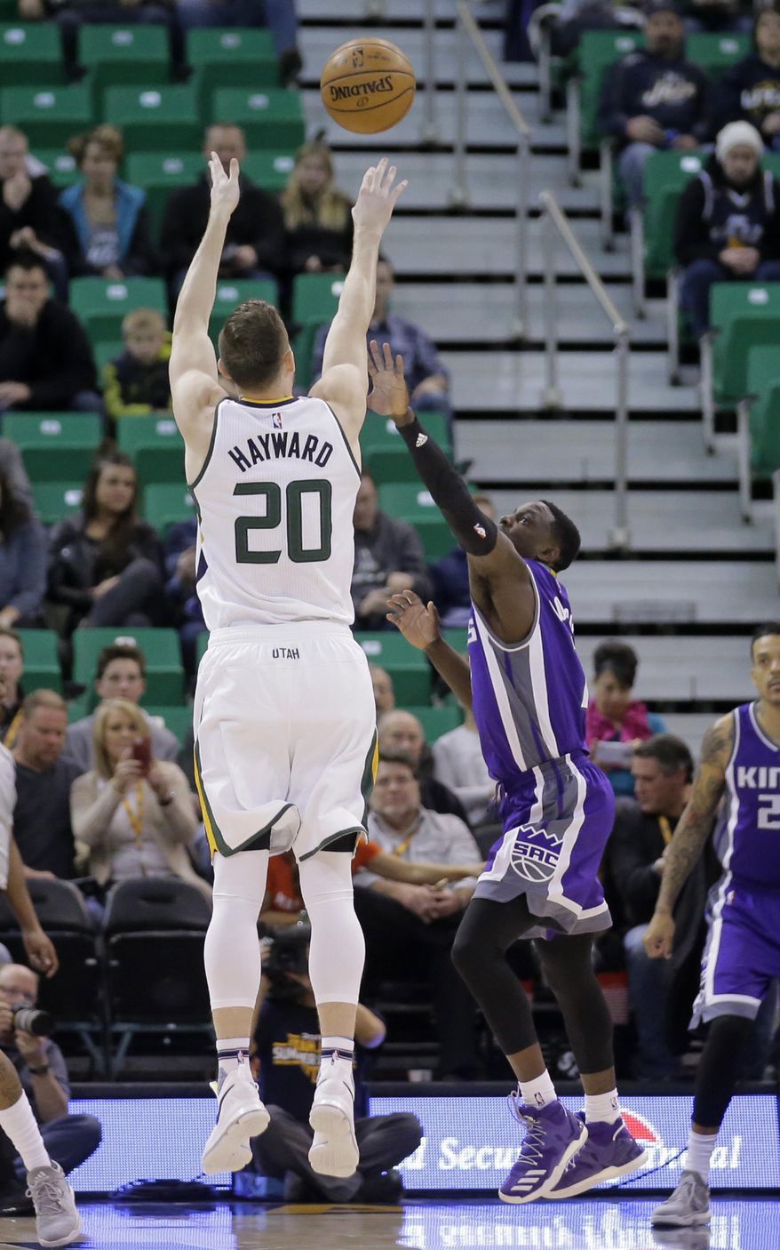 Utah Jazz forward Gordon Hayward (20) shoots as Sacramento Kings guard Darren Collison, right, defends in the first half during an NBA basketball game Wednesday, Dec. 21, 2016, in Salt Lake City. (AP Photo/Rick Bowmer)