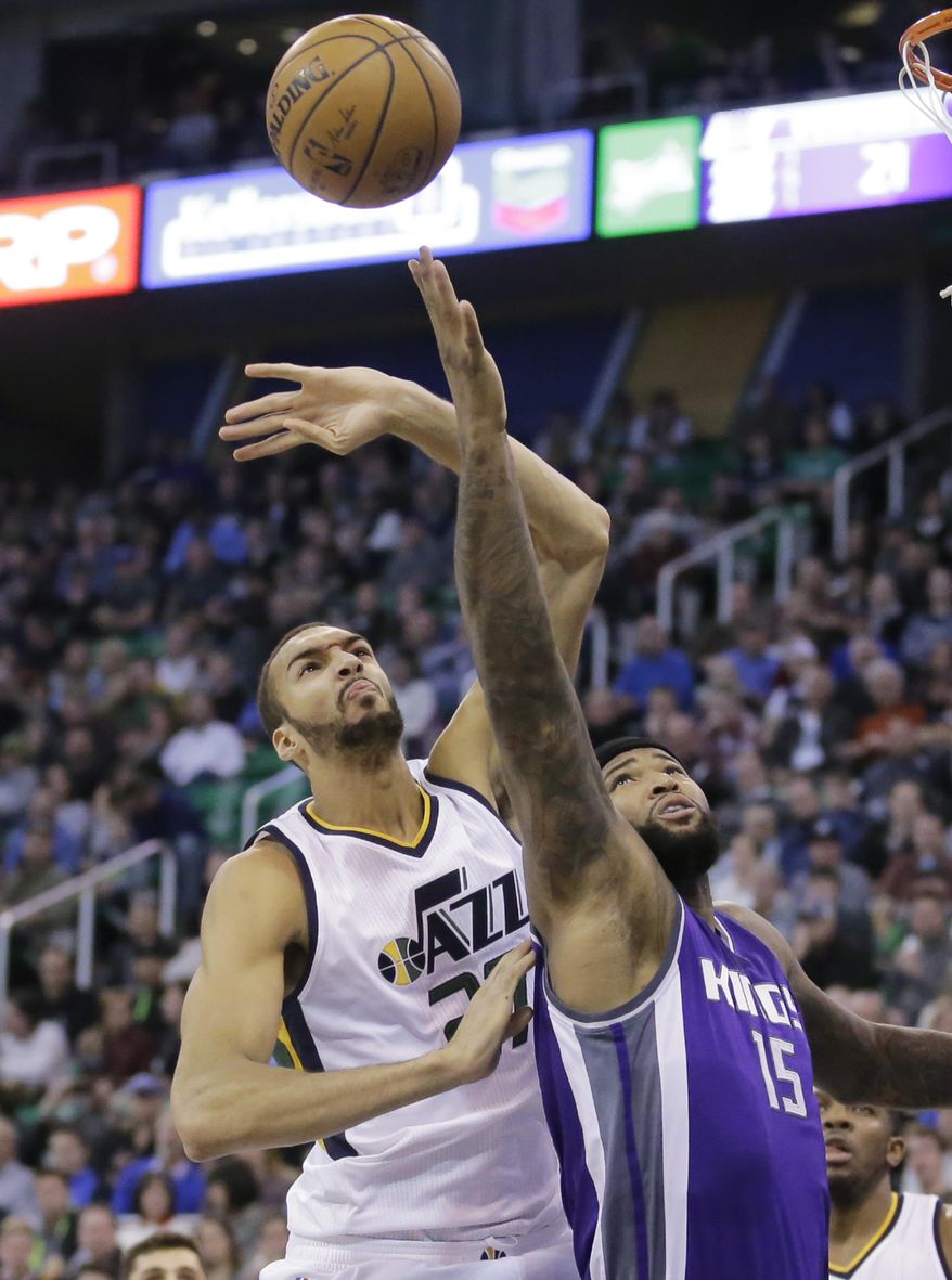 Sacramento Kings forward DeMarcus Cousins (15) and Utah Jazz center Rudy Gobert, left, battle for a rebound in the first half during an NBA basketball game Wednesday, Dec. 21, 2016, in Salt Lake City. (AP Photo/Rick Bowmer)