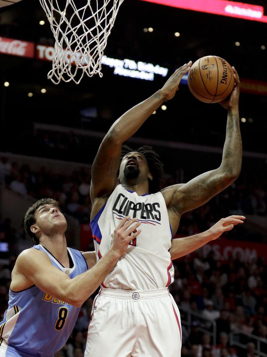 Los Angeles Clippers center DeAndre Jordan, right, shoots over Denver Nuggets forward Danilo Gallinari during the first half of an NBA basketball game in Los Angeles, Tuesday, Dec. 20, 2016. (AP Photo/Chris Carlson)