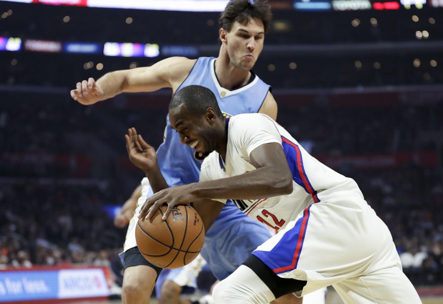 Los Angeles Clippers forward Luc Mbah a Moute, drives to the basket past Denver Nuggets forward Danilo Gallinari during the first half of an NBA basketball game in Los Angeles, Tuesday, Dec. 20, 2016. (AP Photo/Chris Carlson)