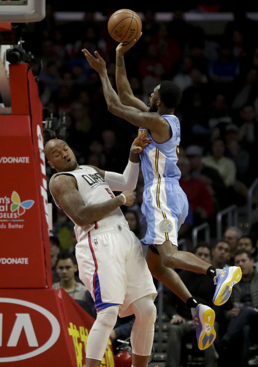 Denver Nuggets guard Will Barton, right, shoots over Los Angeles Clippers center Marreese Speights during the first half of an NBA basketball game in Los Angeles, Tuesday, Dec. 20, 2016. (AP Photo/Chris Carlson)