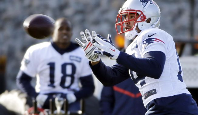New England Patriots wide receiver Michael Floyd catches a pass as Matthew Slater (18) looks on during an NFL football team practice Wednesday, Dec. 21, 2016, in Foxborough, Mass. (AP Photo/Elise Amendola)