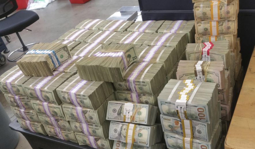 This undated photo provided by U.S. Customs and Border Protection shows cash seized by the U.S. Border Patrol who says it's seized more than $3 million that was being smuggled from the U.S. into Mexico. The cash was found Tuesday, Dec. 20, 2016, inside two cars in Escondido. It's the largest cash seizure ever made by the Border Patrol in San Diego County. (U.S. Customs and Border Protection via AP)
