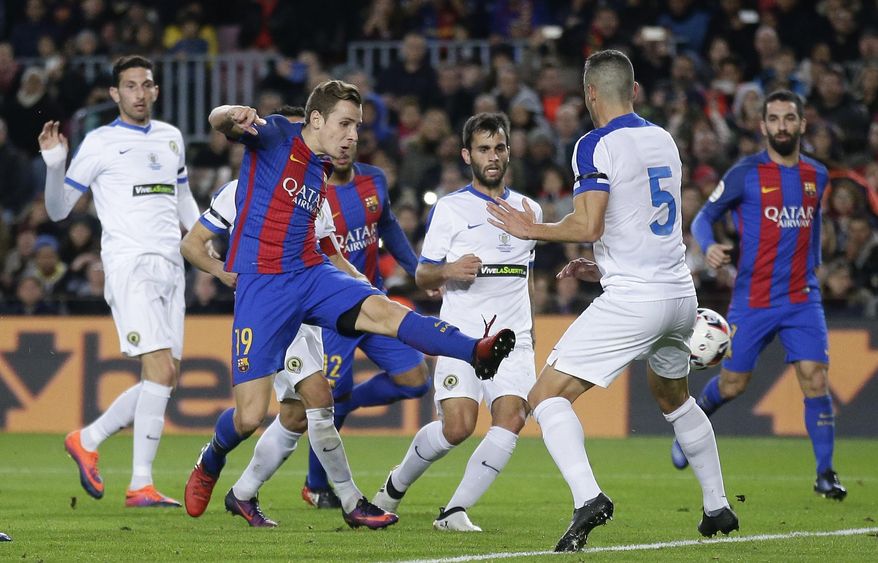 FC Barcelona's Lucas Digne, second left, kicks the ball to scores during the Copa del Rey, Spain's King's Cup soccer match between FC Barcelona and Hercules at the Camp Nou in Barcelona, Spain, Wednesday, Dec. 21, 2016. (AP Photo/Manu Fernandez)