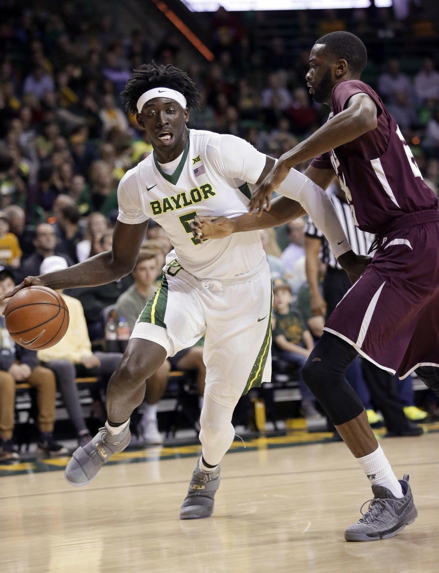 Baylor forward Johnathan Motley (5) drives against Texas Southern center Marvin Jones during the first half of an NCAA college basketball game Wednesday, Dec. 21, 2016, in Waco, Texas. (AP Photo/LM Otero)