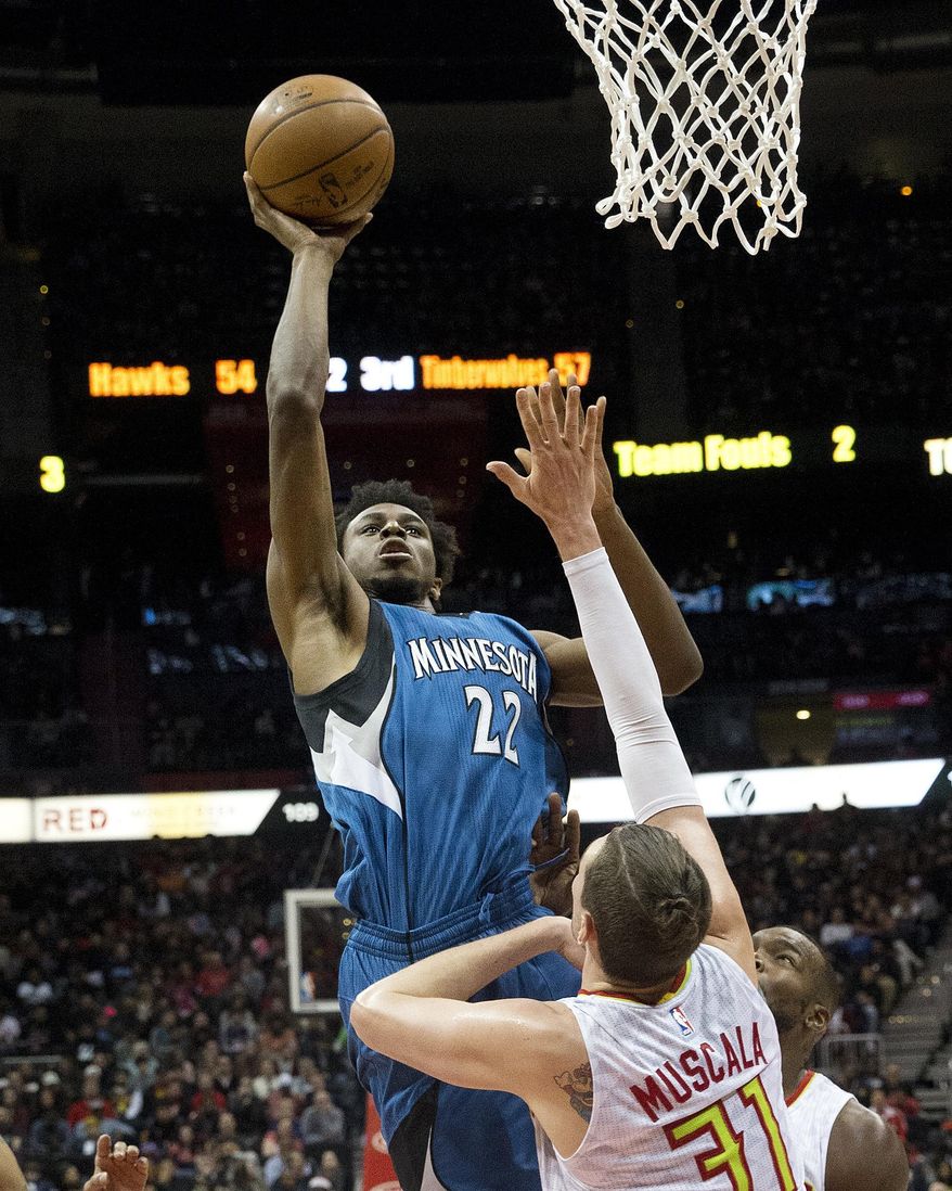 Minnesota Timberwolves forward Andrew Wiggins (22) shoots over Atlanta Hawks forward Mike Muscala (31) in the second half of an NBA basketball game Wednesday, Dec. 21, 2016, in Atlanta. Minnesota won 92-84. (AP Photo/John Bazemore)