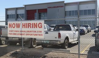 ADVANCE FOR SUNDAY, DEC. 25, 2016- In this Friday, Dec. 16, 2016 photo, prospects for employment in the oil field are beginning to have positive signs as indicated by this hiring sign in front of the Halliburton facility in Odessa, Texas. (Mark Sterkel/Odessa American via AP)