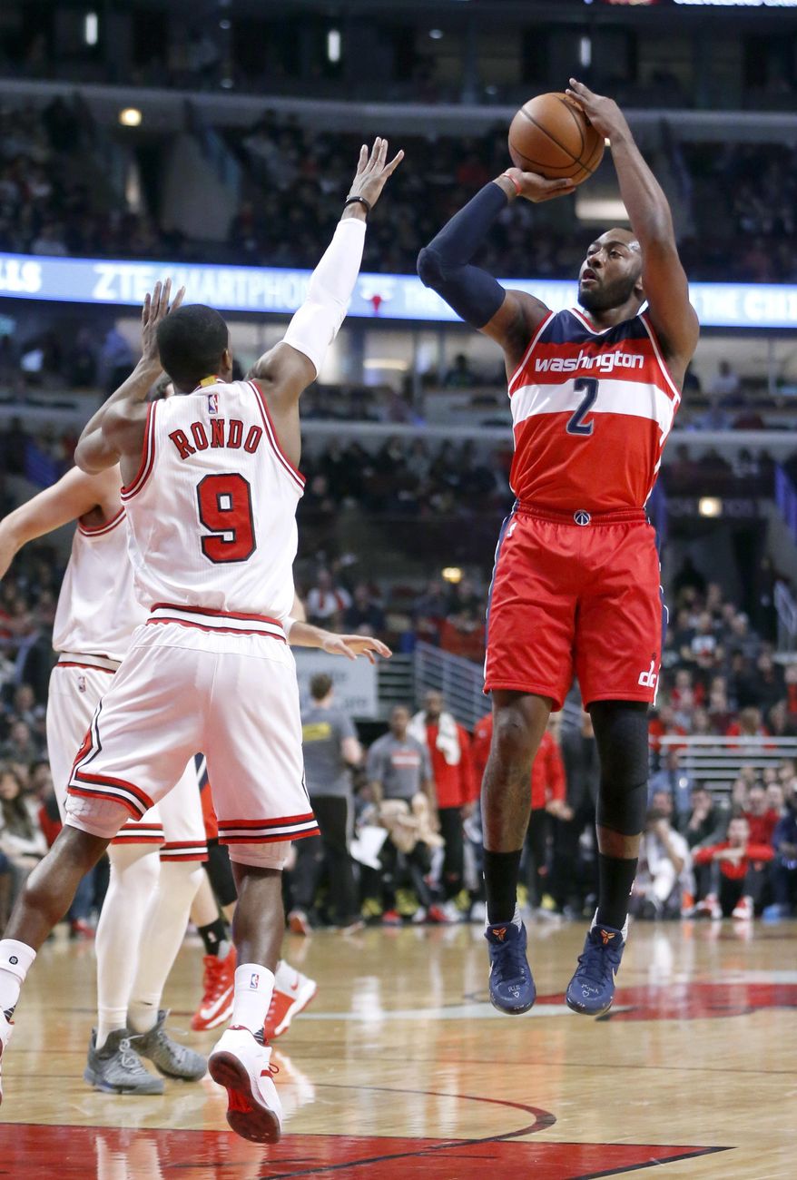 Washington Wizards' John Wall (2) shoots over Chicago Bulls' Rajon Rondo (9) during the first half of an NBA basketball game Wednesday, Dec. 21, 2016, in Chicago. (AP Photo/Charles Rex Arbogast)