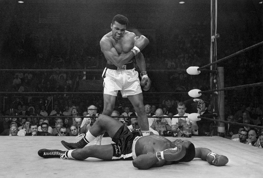 FILE - In this May 25, 1965, file photo, heavyweight champion Muhammad Ali stands over fallen challenger Sonny Liston, shouting and gesturing shortly after dropping Liston with a short hard right to the jaw, in Lewiston, Maine. On that last ride, the one through his hometown, the windshield of the hearse was covered with so many strewn flowers the driver could barely see the road let alone the throngs lining the streets. (AP Photo/John Rooney, File)