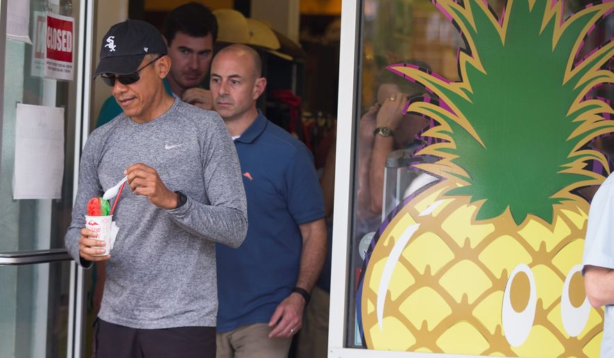 President Barack Obama walks out of Island Snow after paying a visit to get shave ice during a family vacation on Sunday, Dec. 27, 2015, in Kailua, Hawaii. (AP Photo/Evan Vucci)