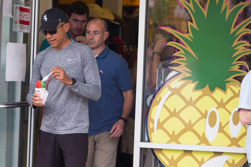 President Barack Obama walks out of Island Snow after paying a visit to get shave ice during a family vacation on Sunday, Dec. 27, 2015, in Kailua, Hawaii. (AP Photo/Evan Vucci)