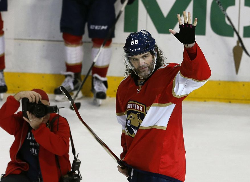 Florida Panthers right wing Jaromir Jagr (68) waves to the crowd after being presented with a golden stick after his assist, giving him 1,888 goals, second most in NHL history during the third period of play against the Boston Bruins in an NHL hockey game, Thursday, Dec. 22, 2016, in Sunrise, Fla. (AP Photo/Joe Skipper)