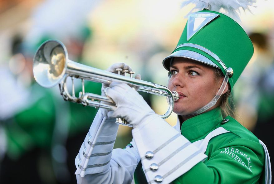 ADVANCE FOR WEEKEND EDITIONS - In this Saturday, Oct. 22, 2016, photo, a member of Marshall University's Marching Thunder performs as Marshall takes on Charlotte during a C-USA football game at Joan C. Edwards Stadium in Huntington, W.Va. The Marching Thunder will perform in the Rome New Year's Day Parade in Rome, Italy, on Jan. 1, 2017. (Sholten Singer/The Register-Herald via AP)